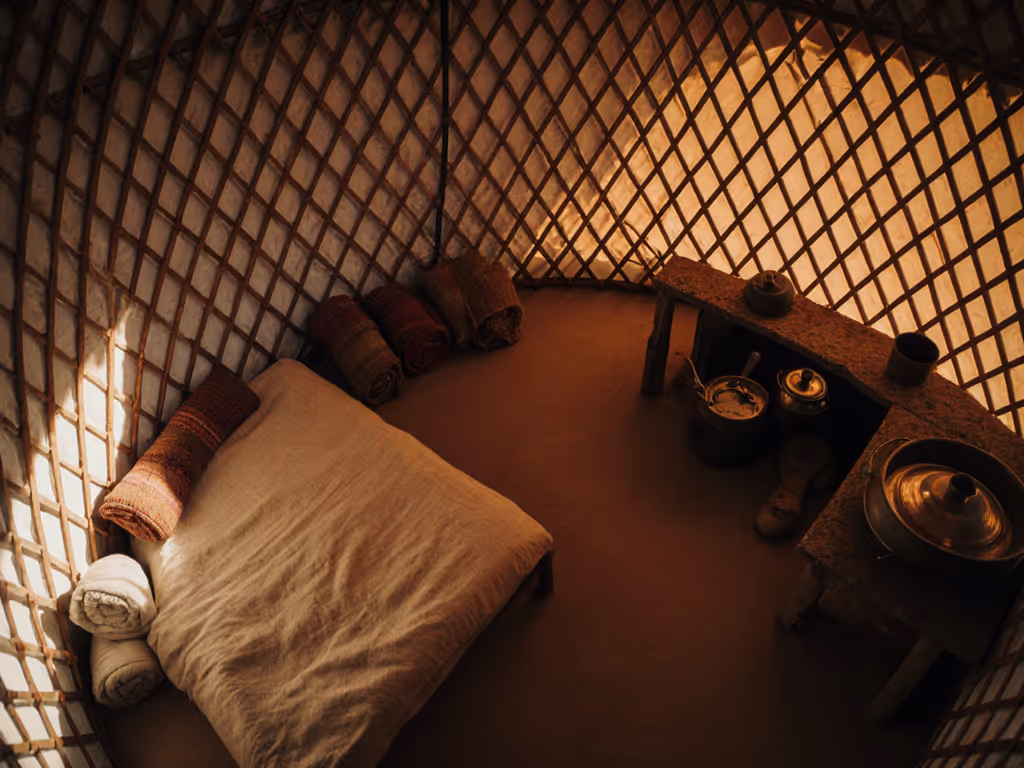 traditional_yurt_interior_with_organized_zones_for_sleeping_and_cooking